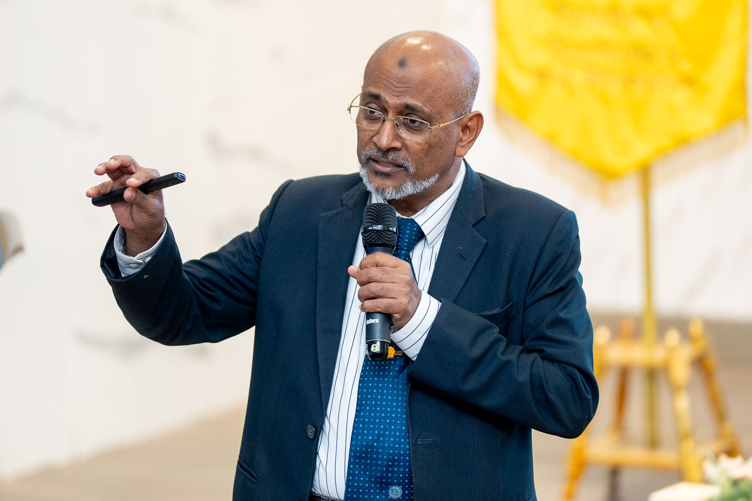 Prof. Dato’ Dr. Ahamed Kameel Mydin Meera speaking at a lecture, holding a microphone